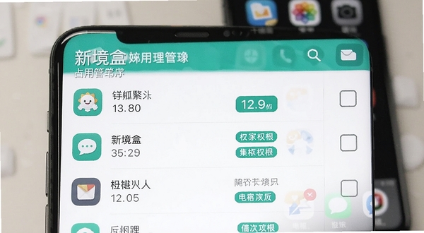 新境盒应用管理列表界面特写,手机屏幕上显示按占用空间排序的应用清单,每行包含应用图标、名称、体积数字和权限标签,右侧有批量选择框,界面配色为白色底配青绿色强调色,画面干净利落,背景为虚化的手机桌面场景,突出工具软件的高效属性