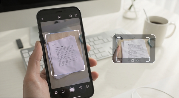 LightPDF Scanner 手机扫描文档界面展示,手机对准纸质文件自动框选边缘,画面简洁明亮,办公桌面场景,浅色调背景,突出扫描识别框与文档预览效果