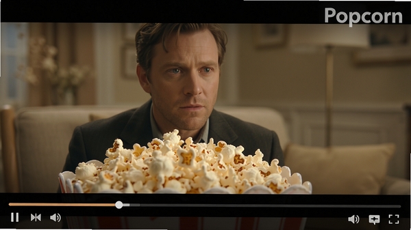 Popcorn��Ƶ���Ž���ϸ��ͼ����������ʾһ�������Ӱ��ͣ���棬��Ƶ�ײ��н������Ϳ��ư�ť���������Ͻ���ʾPopcorn��������ˮӡ������ɫ����ͣ�ͻ�����Ż��ʵ�ϸ��������